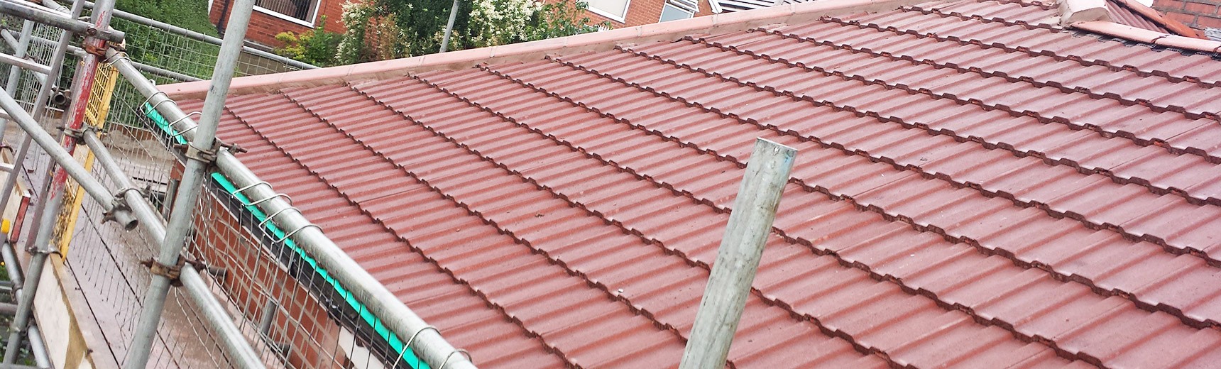 Roofer constructing a tiled roof